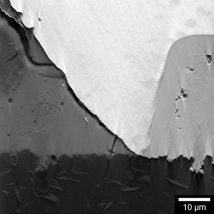 Microcracks visible at interface of solder bump, under bump metallurgy, and polyimide.