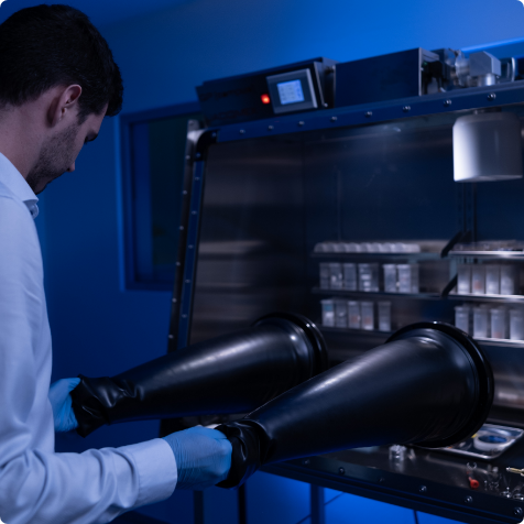 Researcher preparing air-sensitive samples in glove box